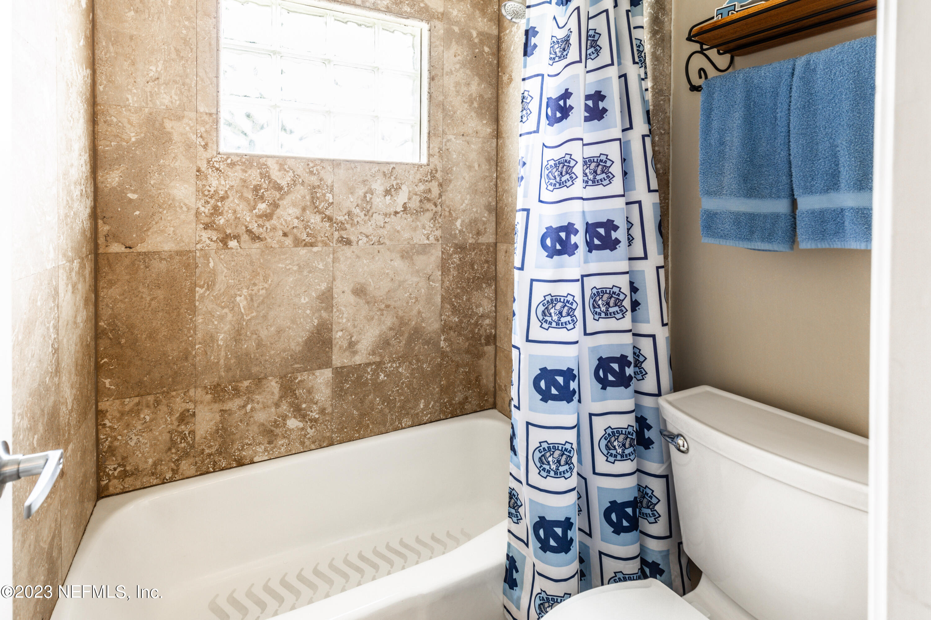 729 Cherry Grove Road Orange Park, FL 32073 - Photo 33 of 47 a bathroom with a bathtub and shower curtain