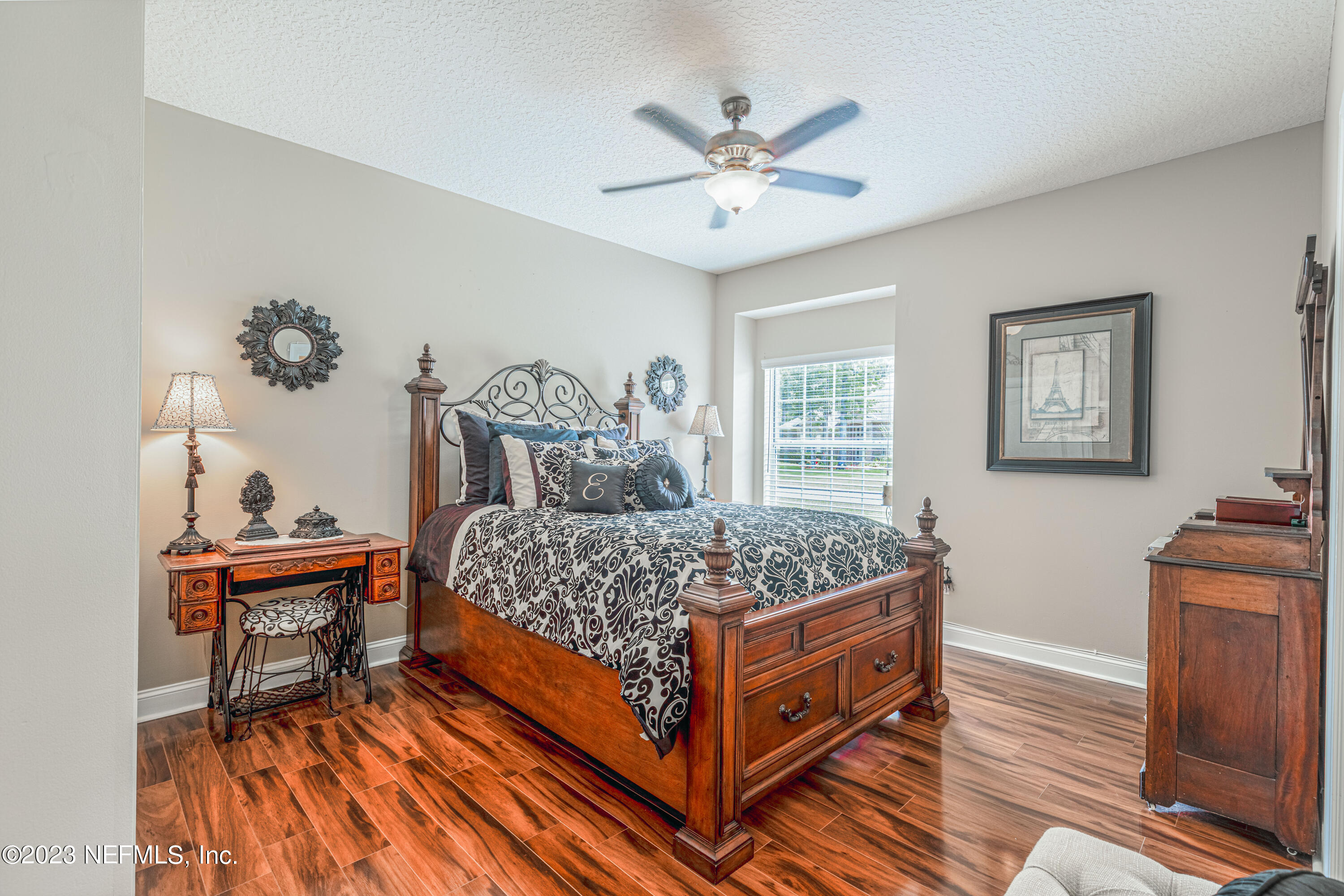 729 Cherry Grove Road Orange Park, FL 32073 - Photo 34 of 47 a bedroom with a bed and a table in it