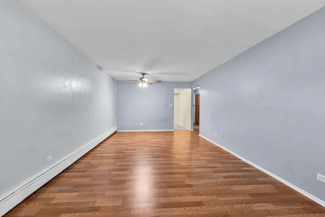 a view of empty room with wooden floor