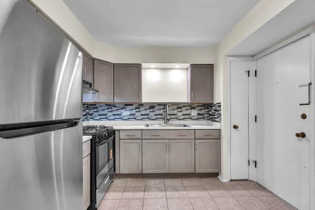 a kitchen with a sink stove and refrigerator