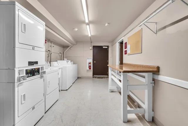 a utility room with cabinets dryer and washer