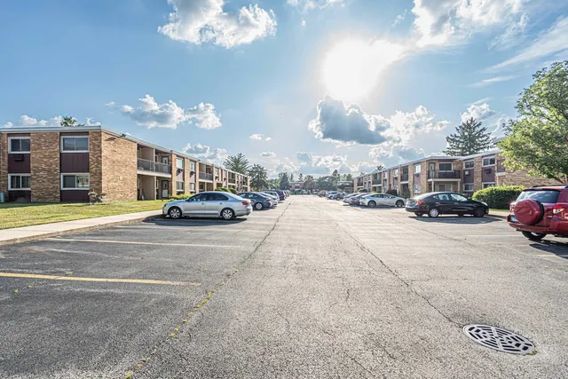 a view of a cars park in front of a building