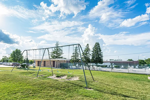 a swimming pool with lots of tress in the background