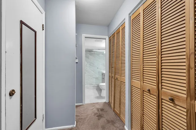 a view of bathroom with a shower and a toilet