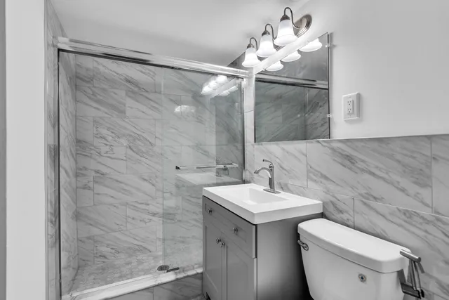 a bathroom with a sink mirror and toilet
