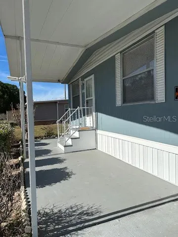 a kitchen with granite countertop white cabinets and sink