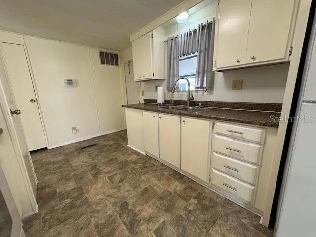 a view of a kitchen with a sink and dishwasher stove top oven