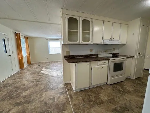 a kitchen with stainless steel appliances a refrigerator and a stove