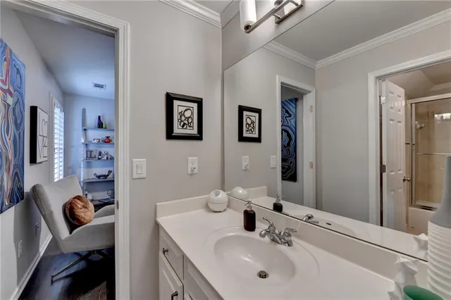 a bathroom with double vanity sink and a mirror