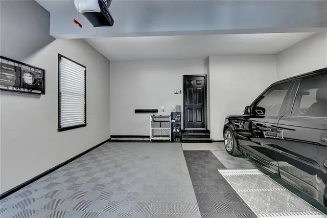 a view of an empty room with furniture and a window