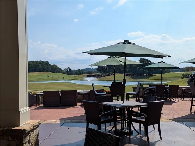 a view of outdoor space with table and chairs under an umbrella