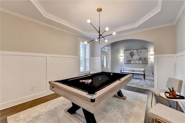 a room with pool table and windows