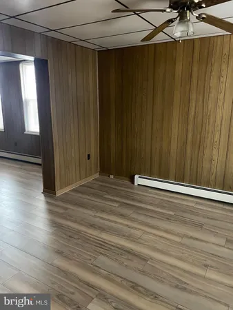 a view of a room with wooden floor