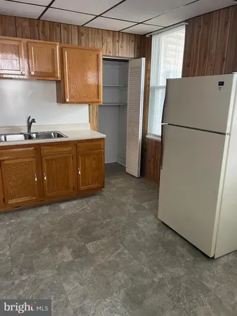 a kitchen with a refrigerator and a sink