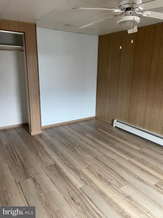 a view of a room with wooden floor