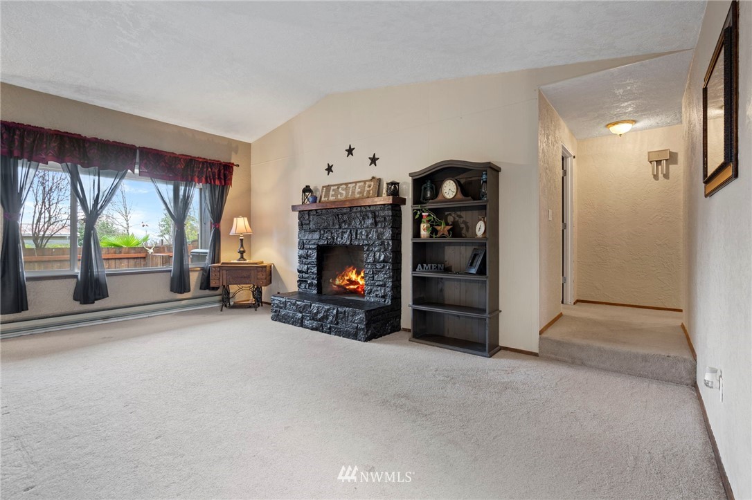 167 Hillcrest Road Chehalis, WA 98532 - Photo 10 of 26 a view of a livingroom with a fireplace and a window