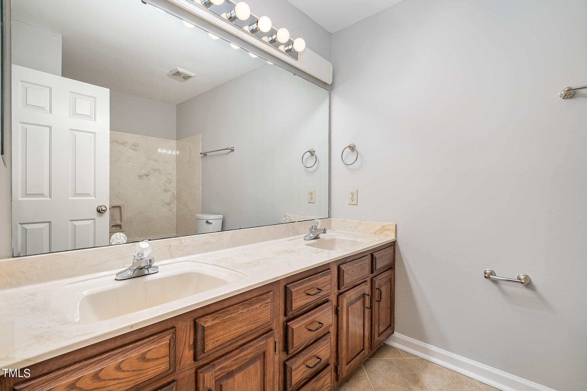 305 Fairwinds Drive Cary, NC 27518 - Photo 16 of 27 a bathroom with a granite countertop sink and a mirror