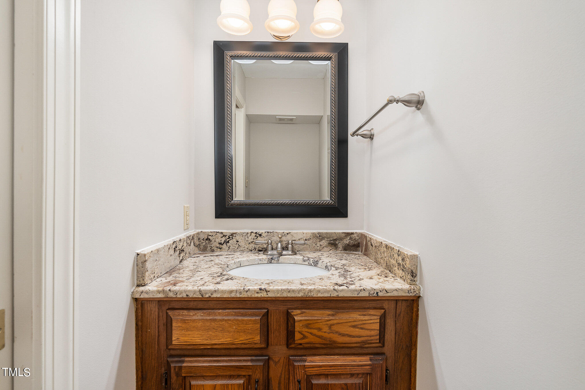 305 Fairwinds Drive Cary, NC 27518 - Photo 17 of 27 a bathroom with a granite countertop sink and a mirror