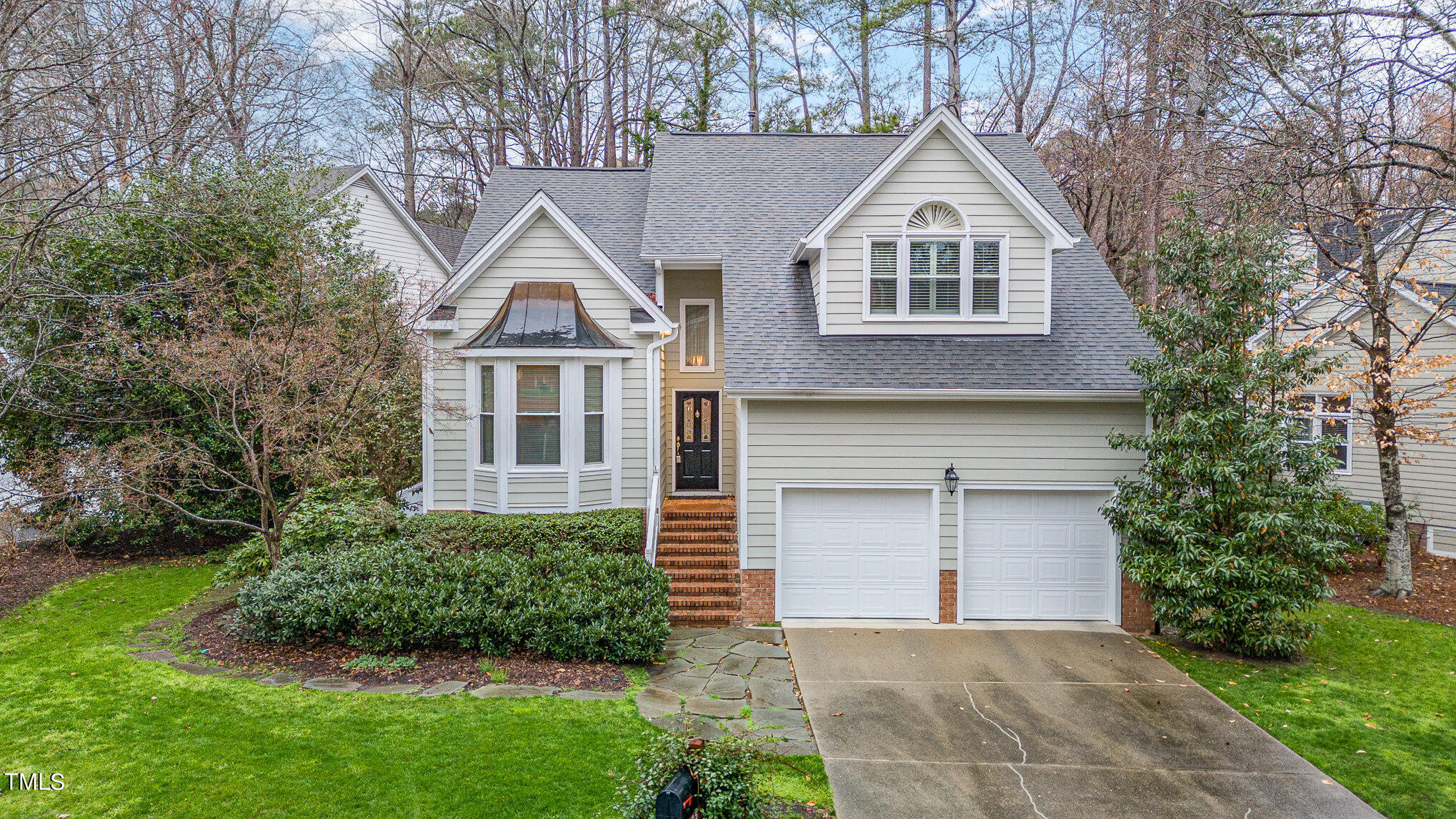 305 Fairwinds Drive Cary, NC 27518 - Photo 22 of 27 a front view of a house with a yard and garage