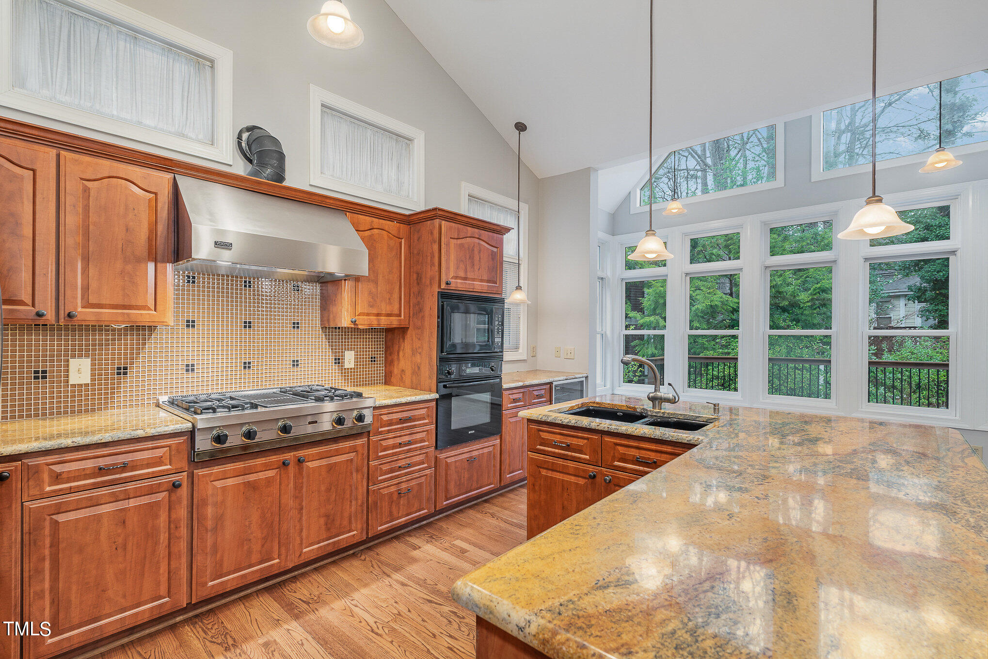 305 Fairwinds Drive Cary, NC 27518 - Photo 3 of 27 a kitchen with stainless steel appliances granite countertop a stove a sink and a refrigerator