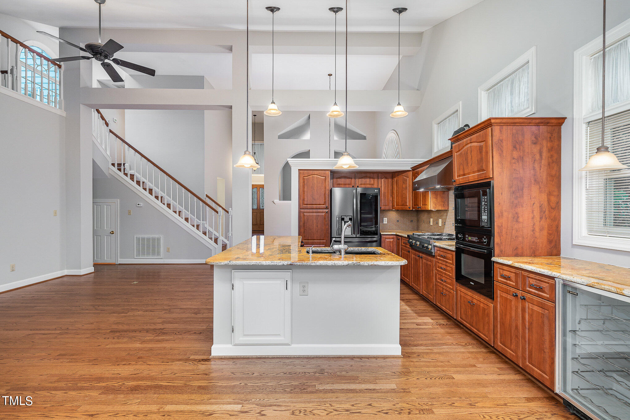 305 Fairwinds Drive Cary, NC 27518 - Photo 26 of 27 a kitchen with stainless steel appliances kitchen island a large counter top and a chandelier