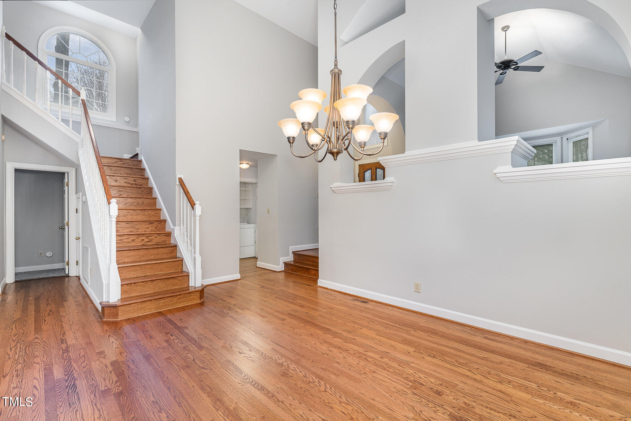 305 Fairwinds Drive Cary, NC 27518 - Photo 6 of 27 a view of a hallway with wooden floor and staircase