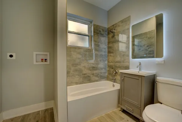 a bathroom with a sink toilet and shower