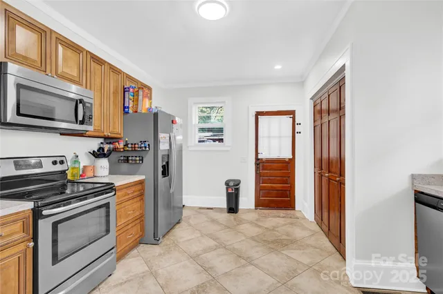 a kitchen with stainless steel appliances granite countertop a refrigerator and a stove top oven