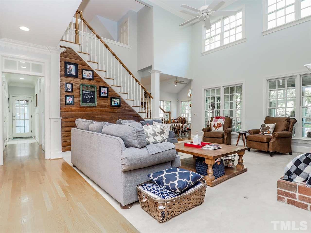 1408 Ridge Side Place Raleigh, NC 27613 - Photo 11 of 25 a living room with furniture couches and a dining table with wooden floor