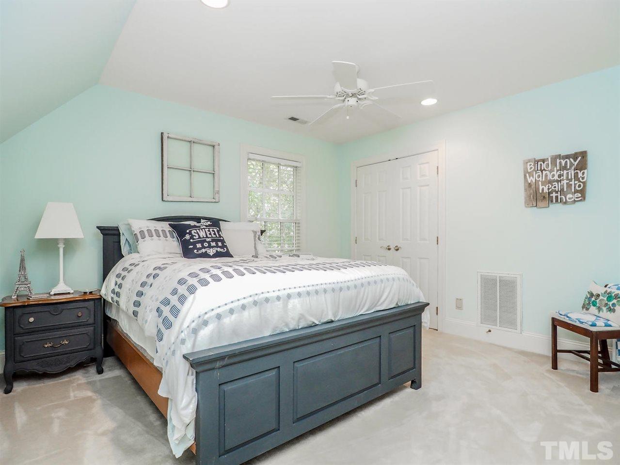 1408 Ridge Side Place Raleigh, NC 27613 - Photo 18 of 25 a spacious bedroom with a bed and a table in it