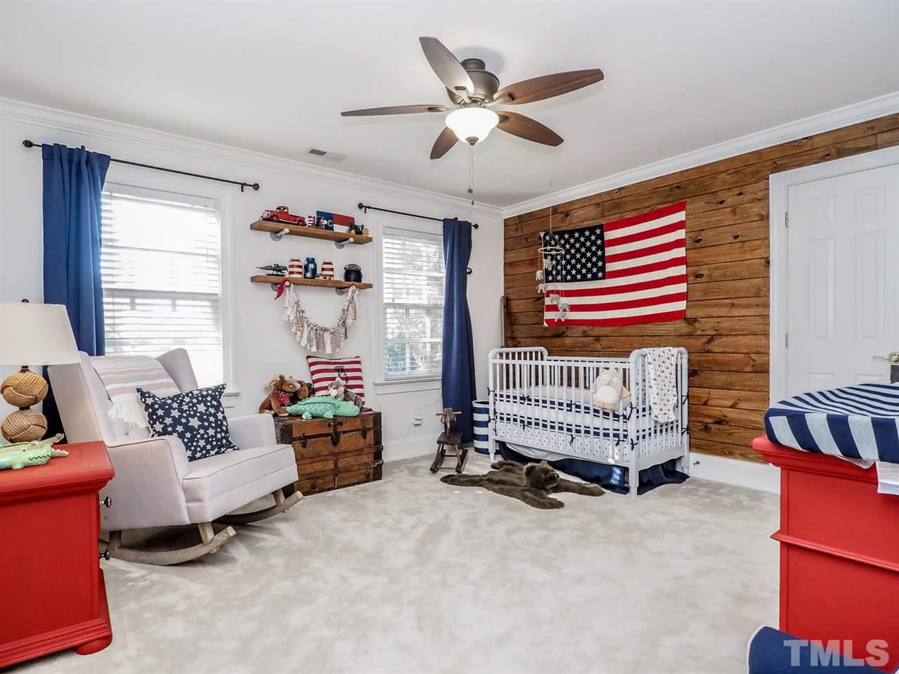 1408 Ridge Side Place Raleigh, NC 27613 - Photo 20 of 25 a bedroom with a bed and a chandelier