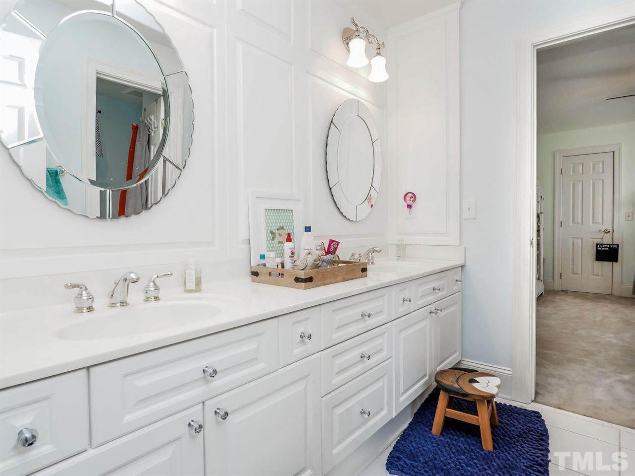 1408 Ridge Side Place Raleigh, NC 27613 - Photo 21 of 25 a bathroom with a sink mirror and vanity