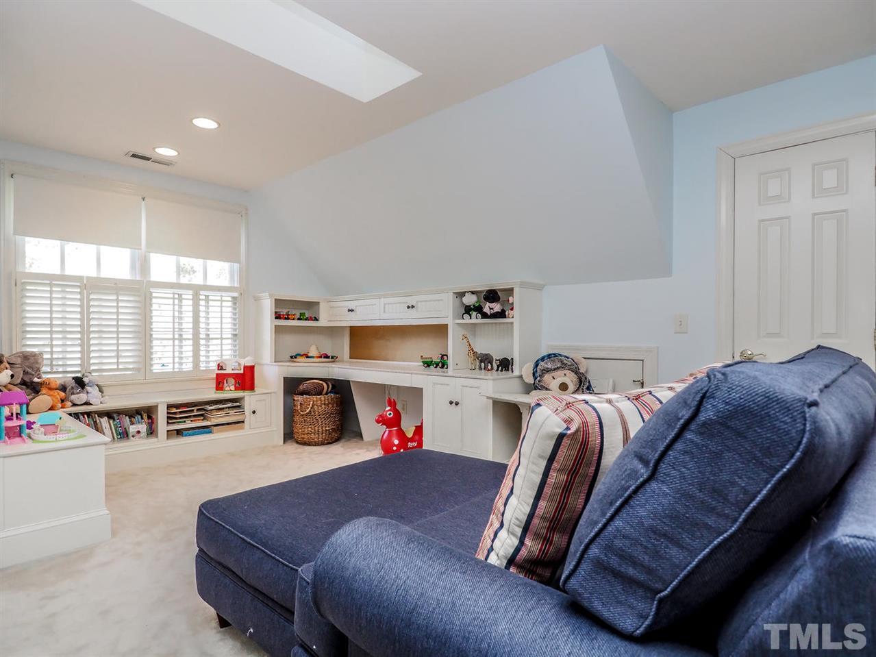 1408 Ridge Side Place Raleigh, NC 27613 - Photo 22 of 25 a bedroom with a bed and a couch