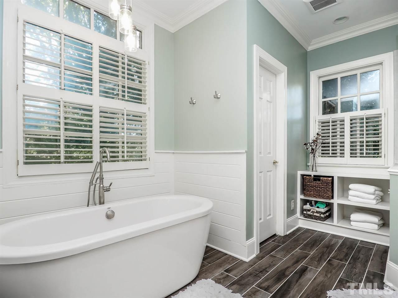 1408 Ridge Side Place Raleigh, NC 27613 - Photo 9 of 25 a bathroom with a bathtub and window