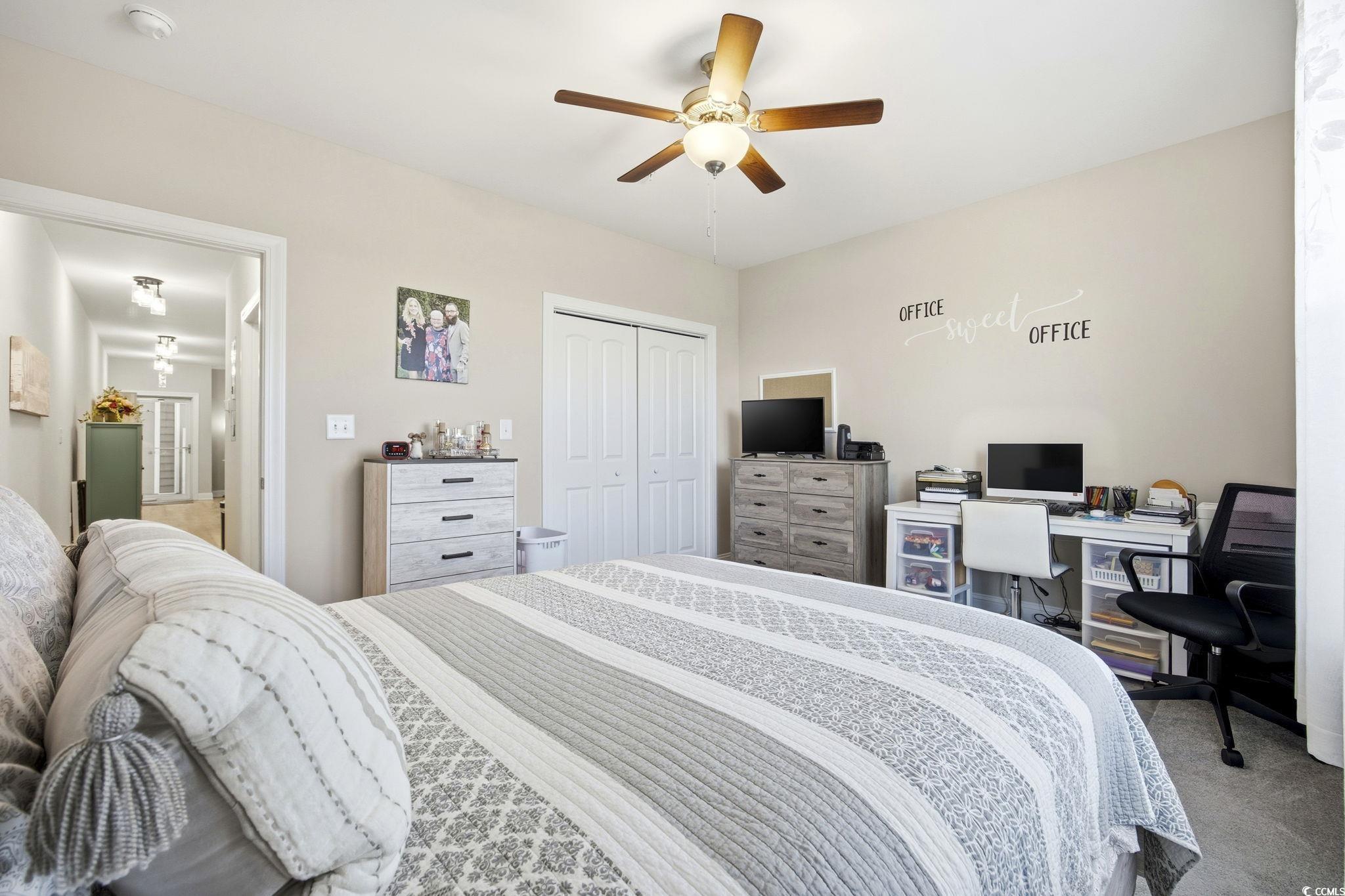 165 Ella Kinley Circle, Unit 302 Myrtle Beach, SC 29588 - Photo 17 of 38 Bedroom with carpet floors, a ceiling fan, a closet, and a desk
