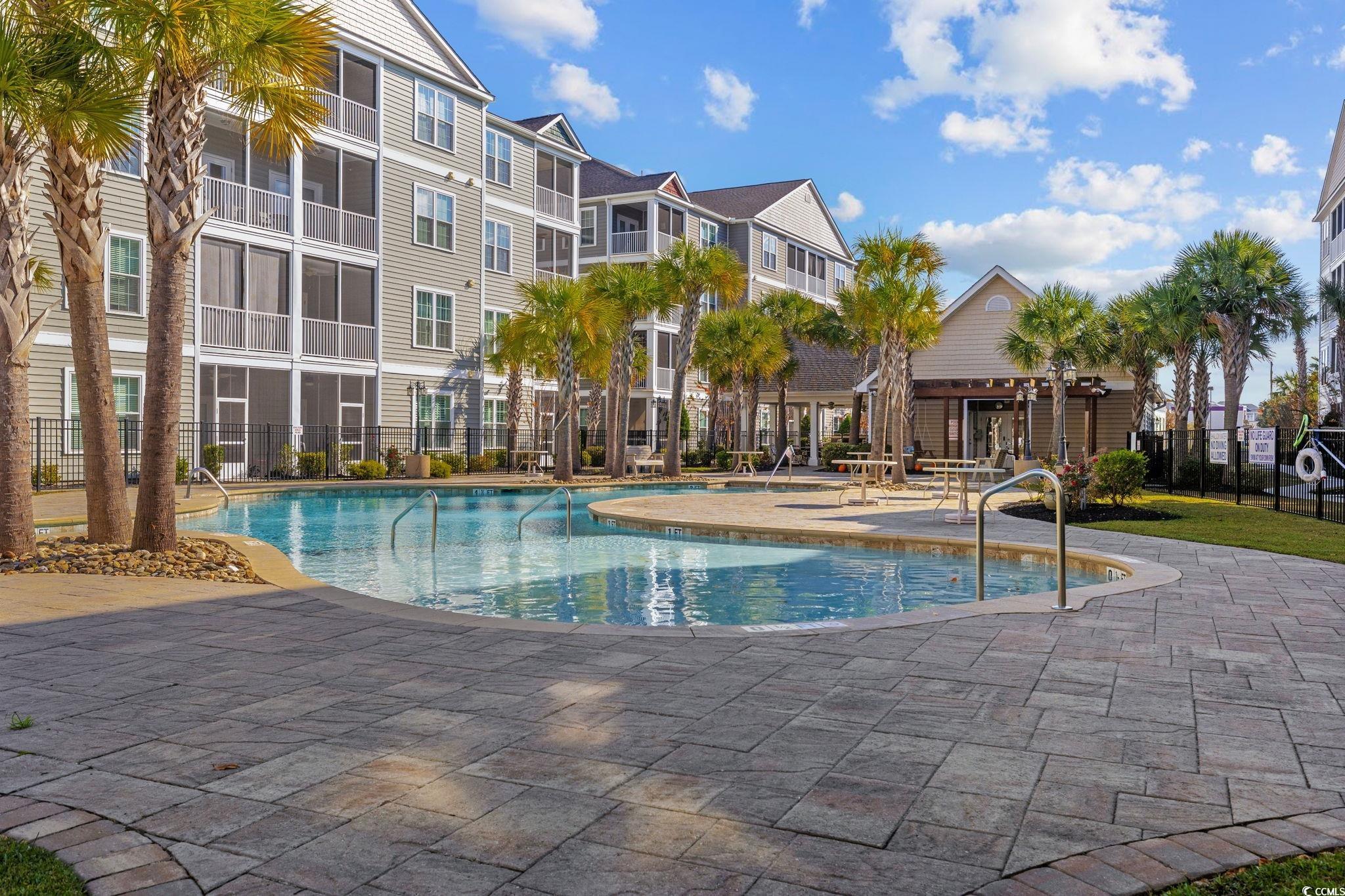 165 Ella Kinley Circle, Unit 302 Myrtle Beach, SC 29588 - Photo 36 of 38 Community pool with a patio area