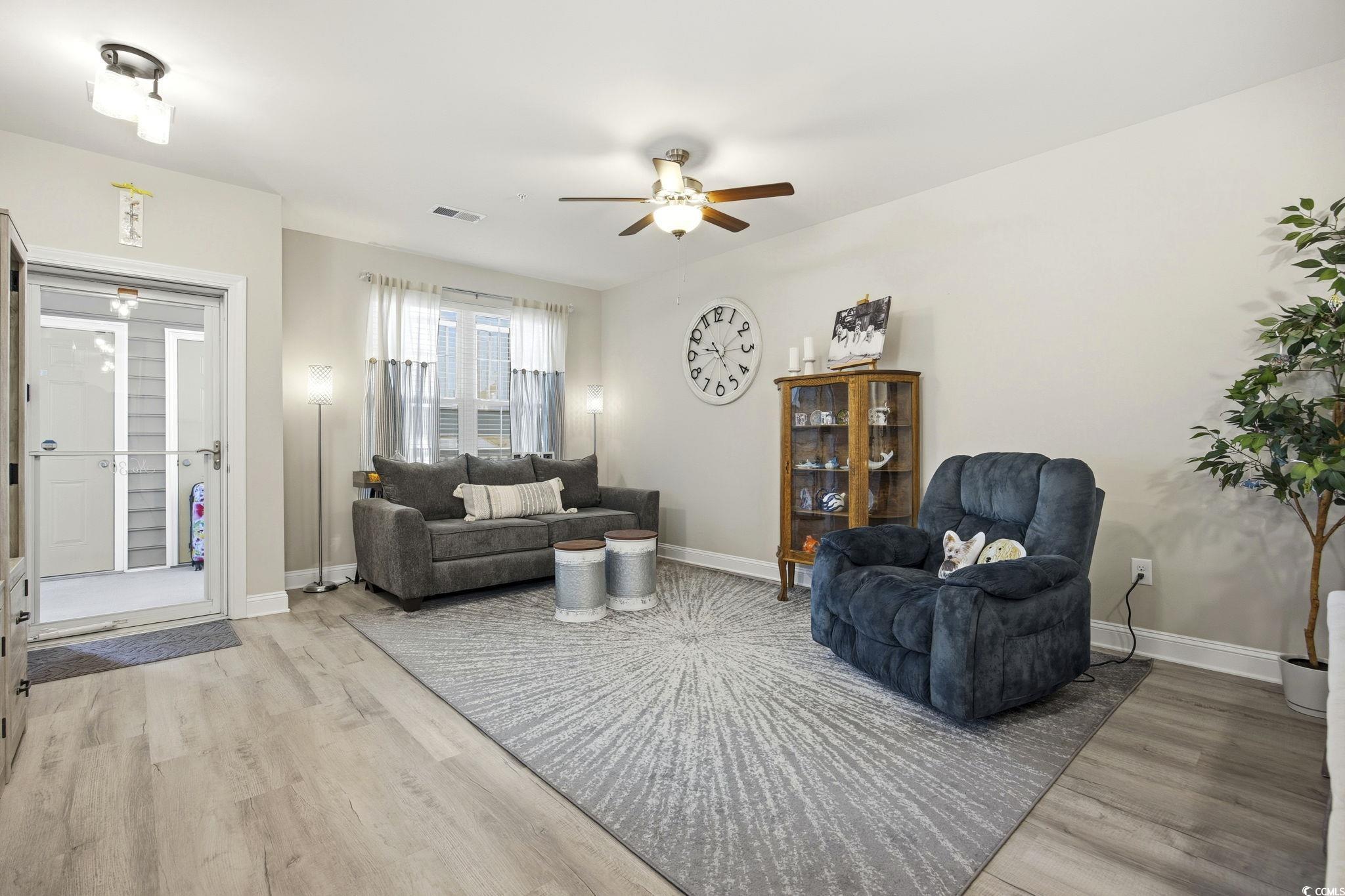 165 Ella Kinley Circle, Unit 302 Myrtle Beach, SC 29588 - Photo 4 of 38 Living room featuring ceiling fan and light wood finished floors
