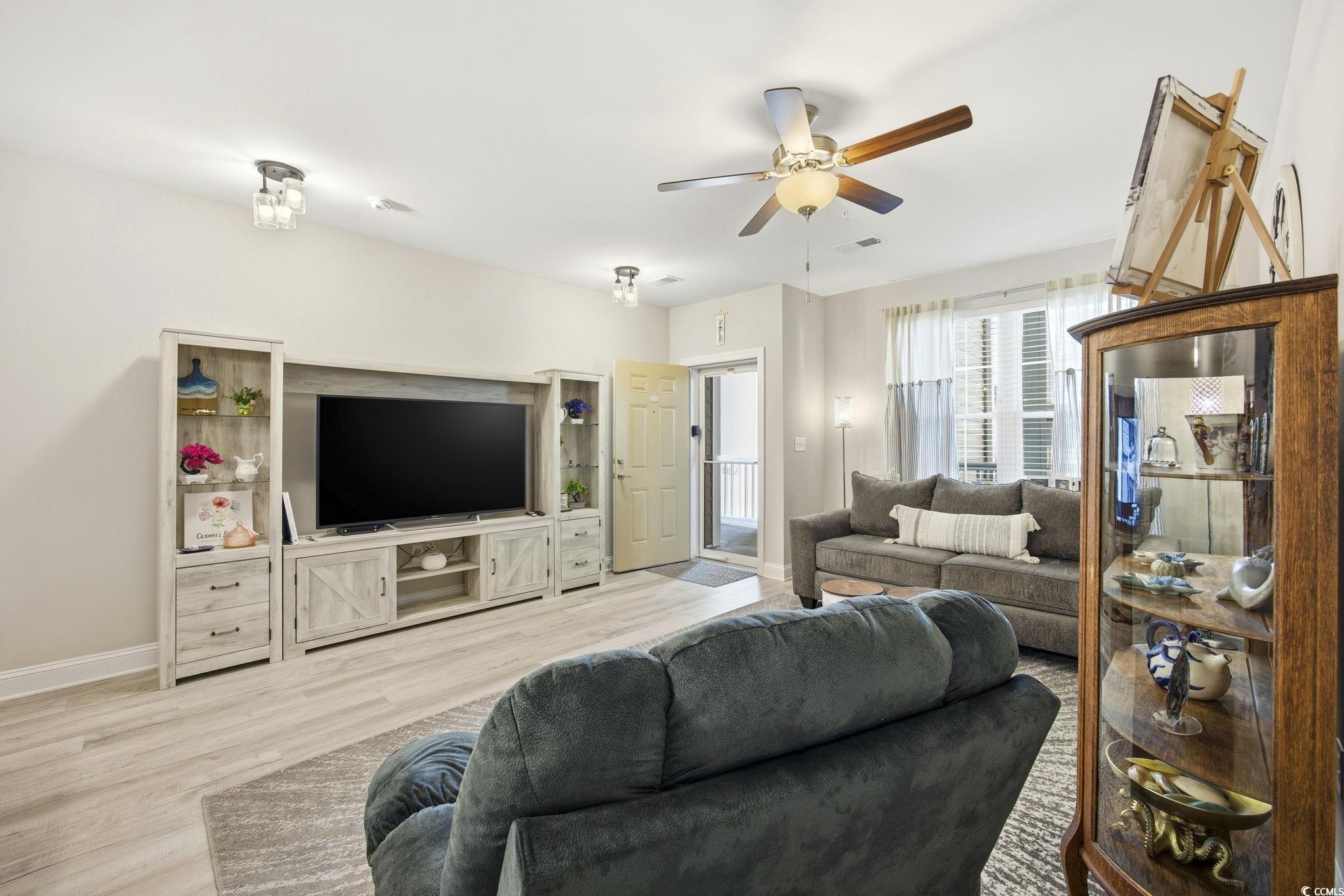 165 Ella Kinley Circle, Unit 302 Myrtle Beach, SC 29588 - Photo 5 of 38 Living room with wood finished floors and a ceiling fan