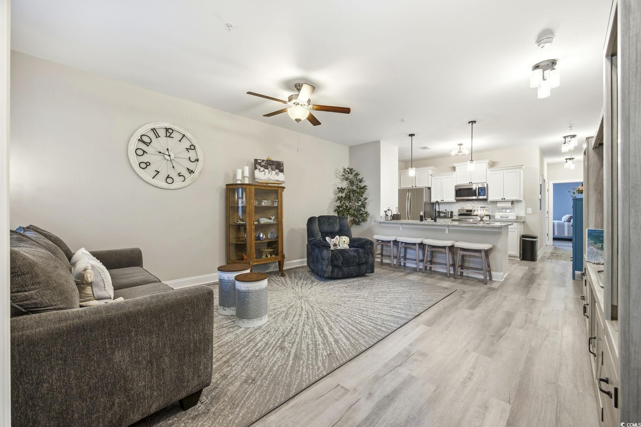 165 Ella Kinley Circle, Unit 302 Myrtle Beach, SC 29588 - Photo 7 of 38 Living room featuring ceiling fan and light wood-type flooring