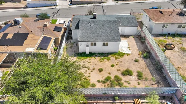 an aerial view of a house with a yard