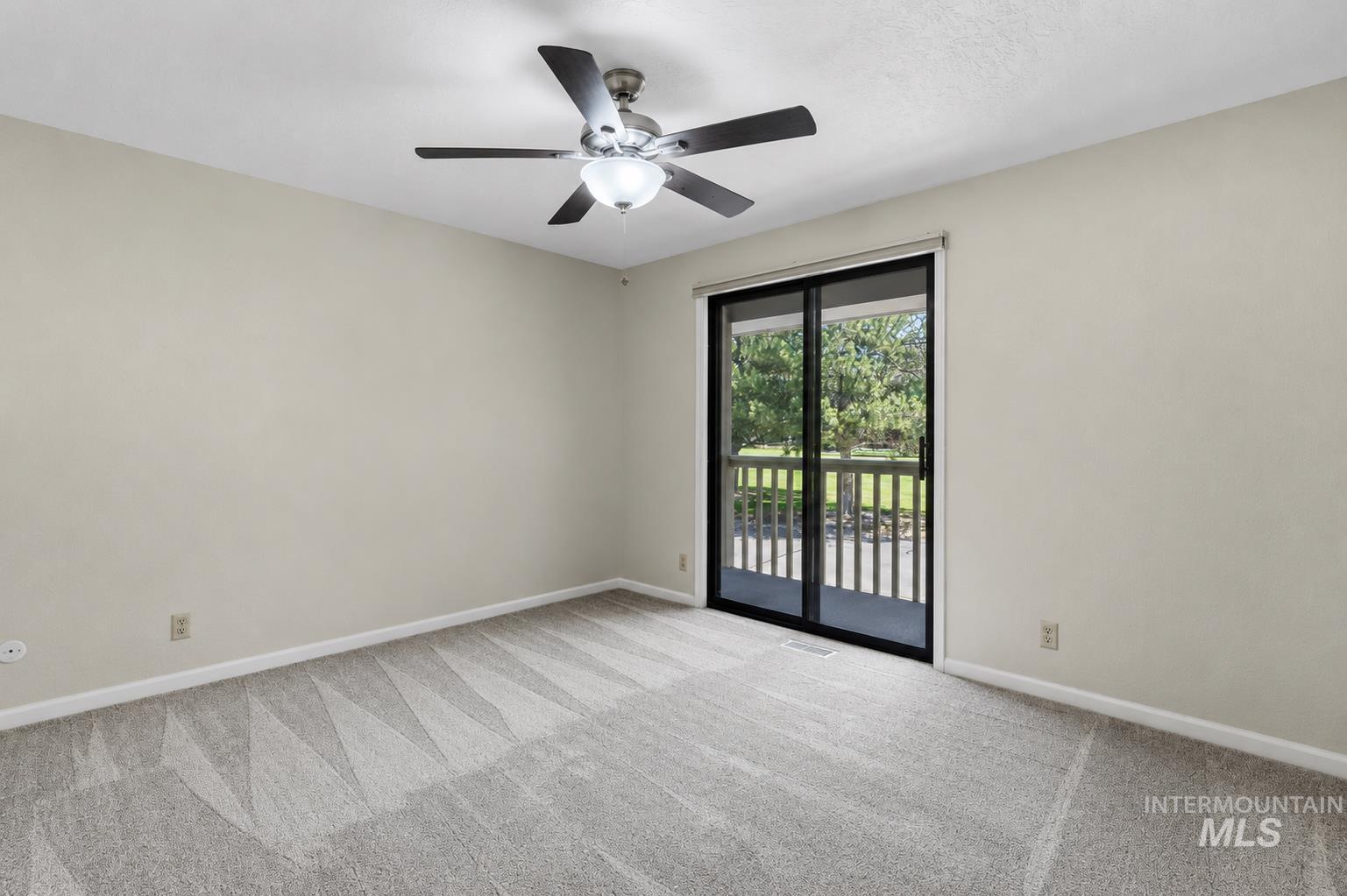 599 Pebble Beach Way Eagle, ID 83616 - Photo 30 of 44 Spacious room featuring neutral carpeting, light-toned walls, and a ceiling fan with integrated lighting