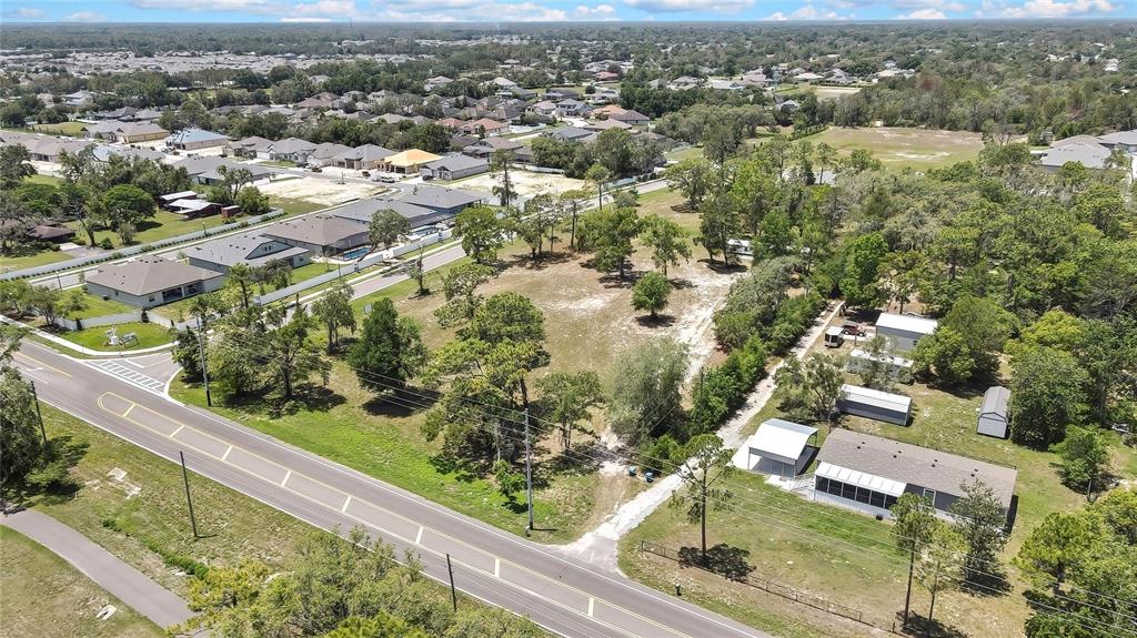 1087 Anderson Snow Road Spring Hill, FL 34609 - Photo 2 of 10 an aerial view of residential houses with outdoor space and trees