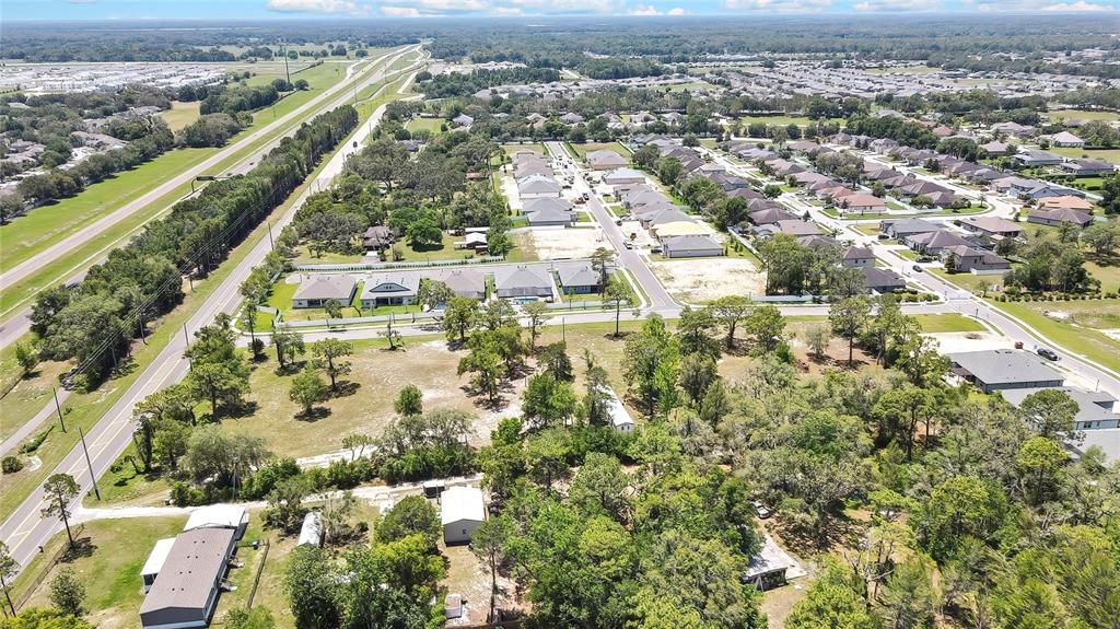 1087 Anderson Snow Road Spring Hill, FL 34609 - Photo 3 of 10 an aerial view of residential houses with outdoor space