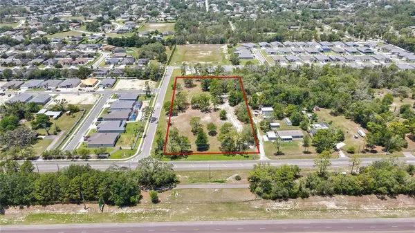 an aerial view of residential houses with yard