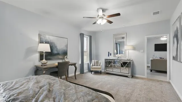 a bedroom with bed and a chandelier