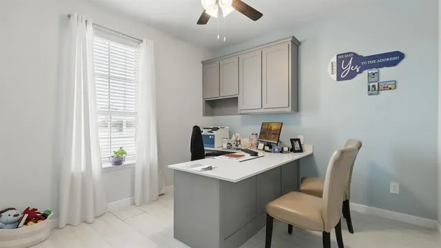 a work place with furniture and windows