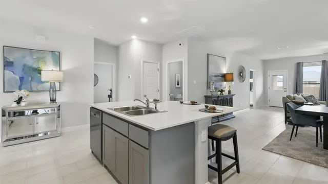 a kitchen with a sink cabinets and utility