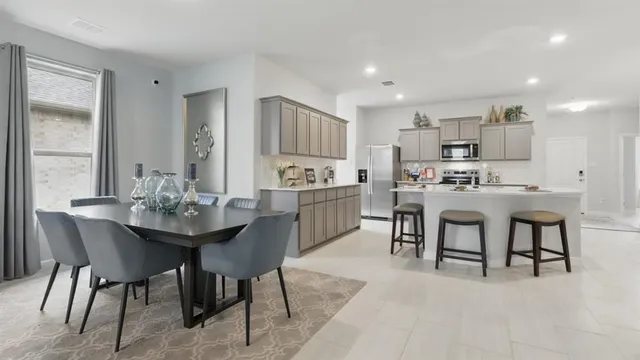 a kitchen with kitchen island a sink stove and refrigerator