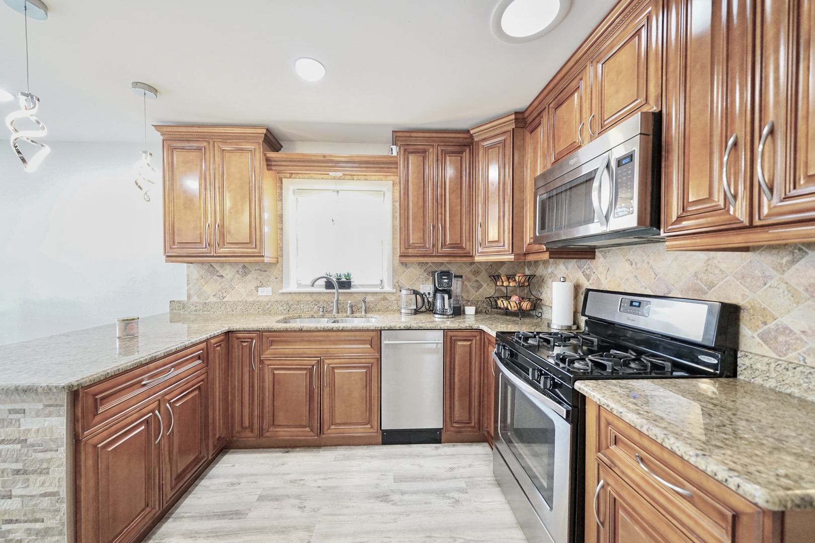 7122 Agatite Avenue Norridge, IL 60706 - Photo 13 of 64 a kitchen with stainless steel appliances granite countertop a stove sink and cabinets