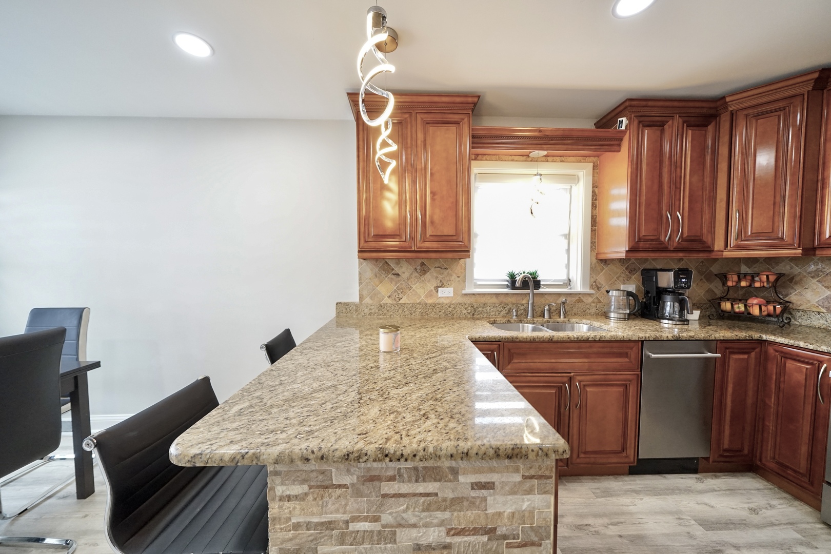 7122 Agatite Avenue Norridge, IL 60706 - Photo 18 of 64 a kitchen with a sink window and cabinets